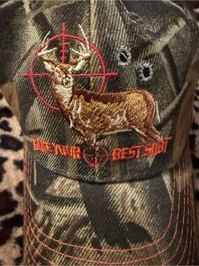 Green camouflage hat with a buck on the front